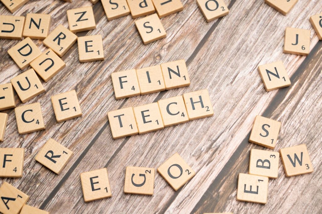Stripe and Airwallex: From Acquisition Talk to Rivalry scrabble tiles spelling the word fin tech on a wooden surface