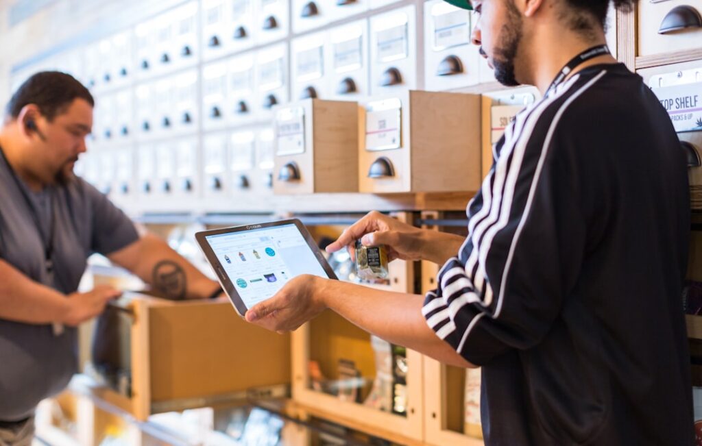 Top Retail Accounting Software for 2024 two men in a store looking at a tablet