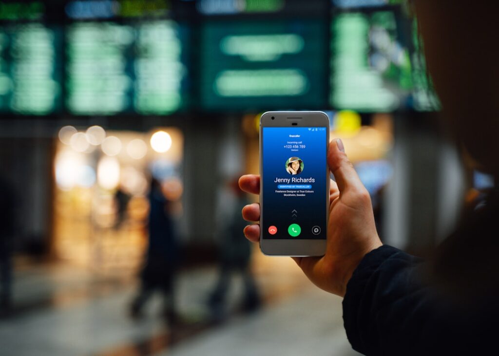 Truecaller Pivots Strategy as Growth Plateau Looms person holding silver iphone 6
