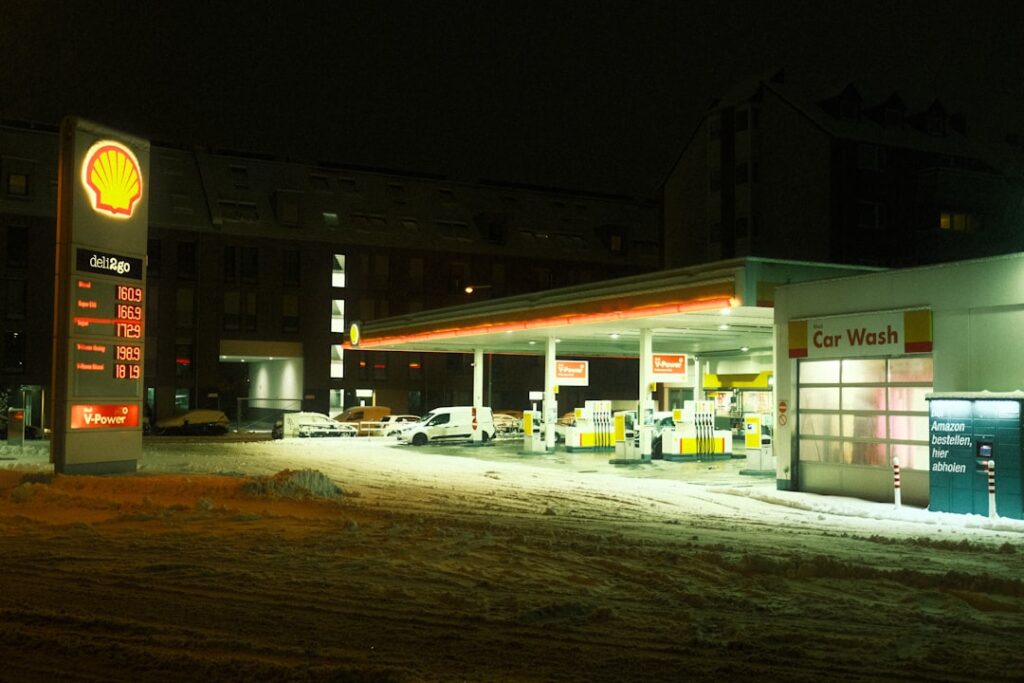 UK Fuel Prices Finally Drop After Weeks of Climbing a gas station at night with snow on the ground