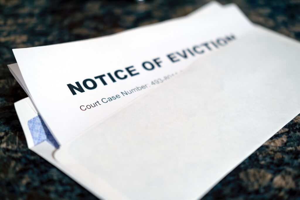 UK Landlords Battle Rising Rent Debt, Eviction Hurdles a close up of a piece of paper with a notice of eviction on it