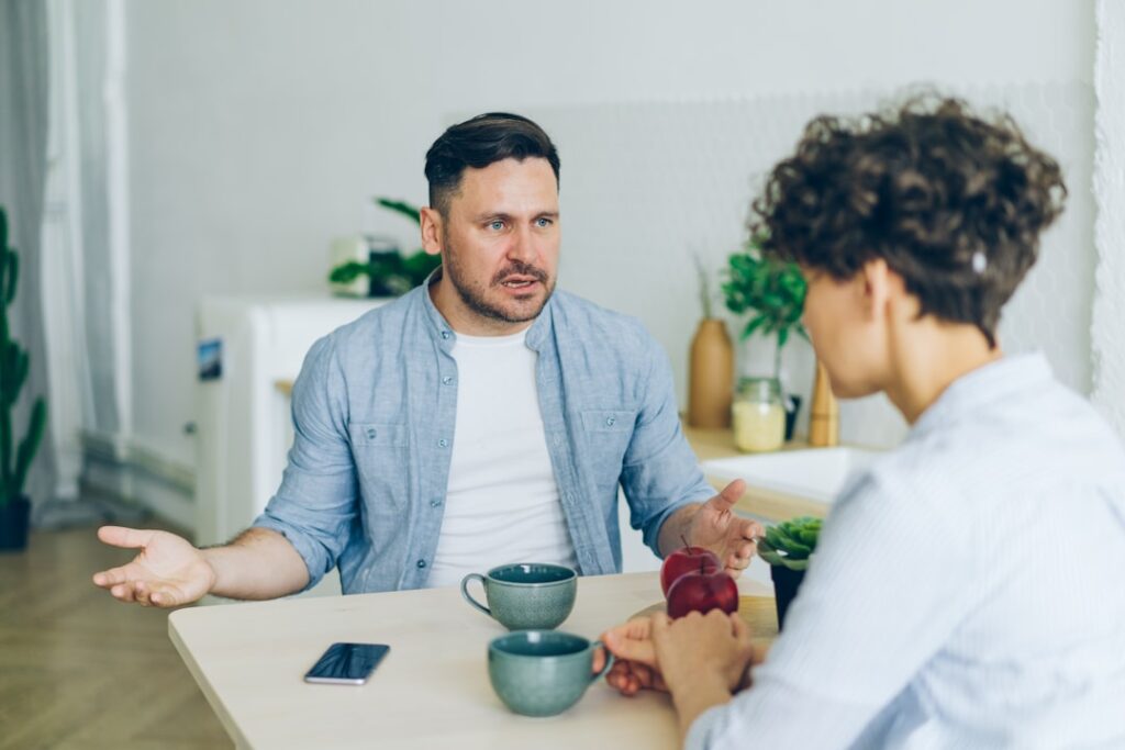 Why Bad Clients Cost More Than Good Ones a man sitting at a table talking to a woman