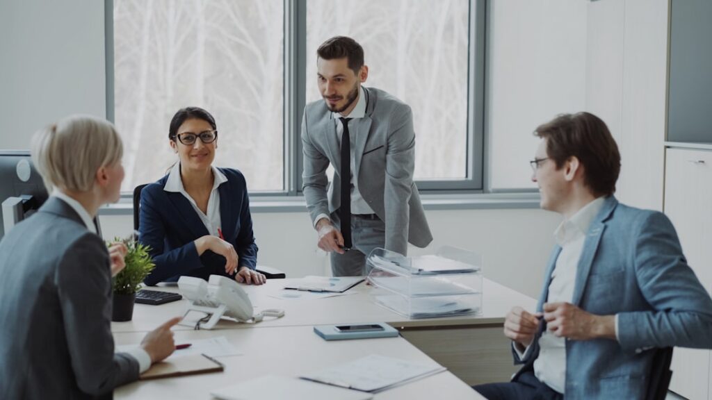 Why Being a Team Player Beats Individual Stardom Business professionals collaborating around a conference table.