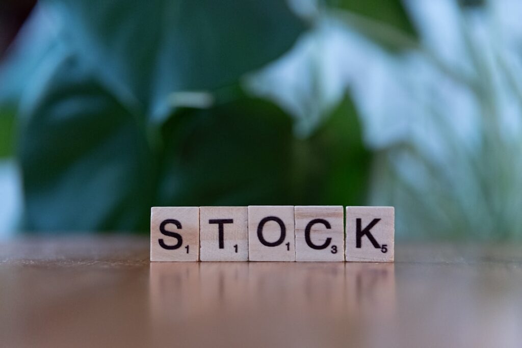 Xiao-I Corporation Restructures ADS Ratio for Shareholders A wooden block spelling the word stock on a table