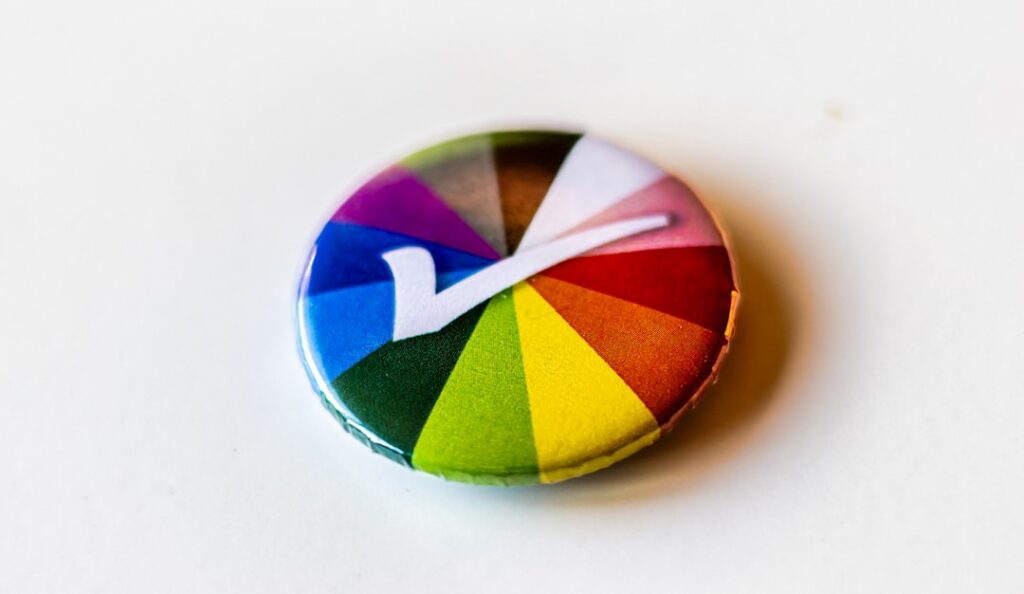 Zoom Partners With World for Human Verification A colorful button with a letter v on it