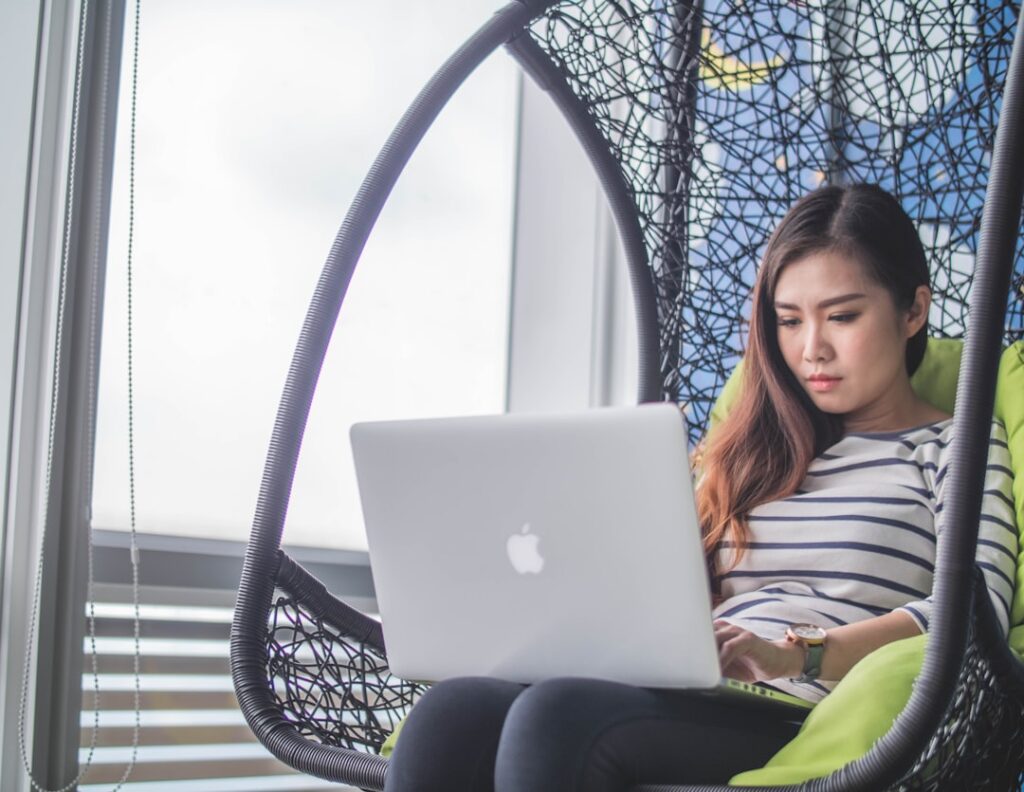 $50M Brand Built by One Woman With 7 Employees MacBook on woman's lap
