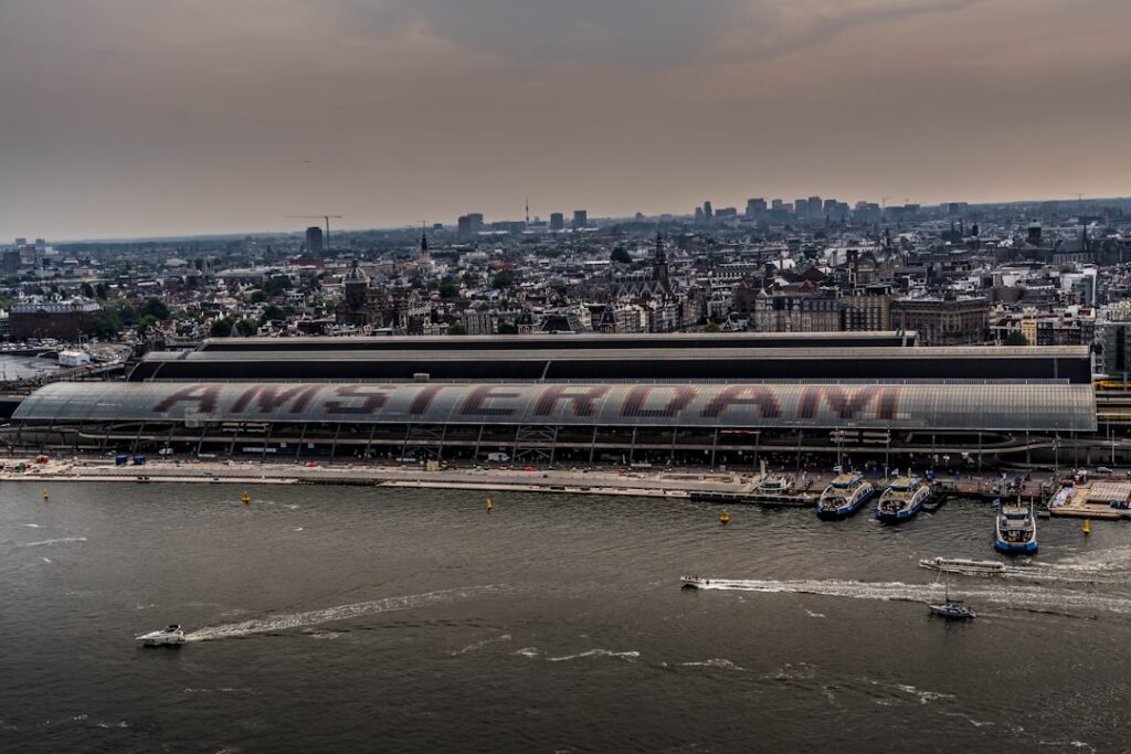 Amsterdam Bans Meat and Fossil Fuel Ads in Bold Climate Move a train on a bridge over water