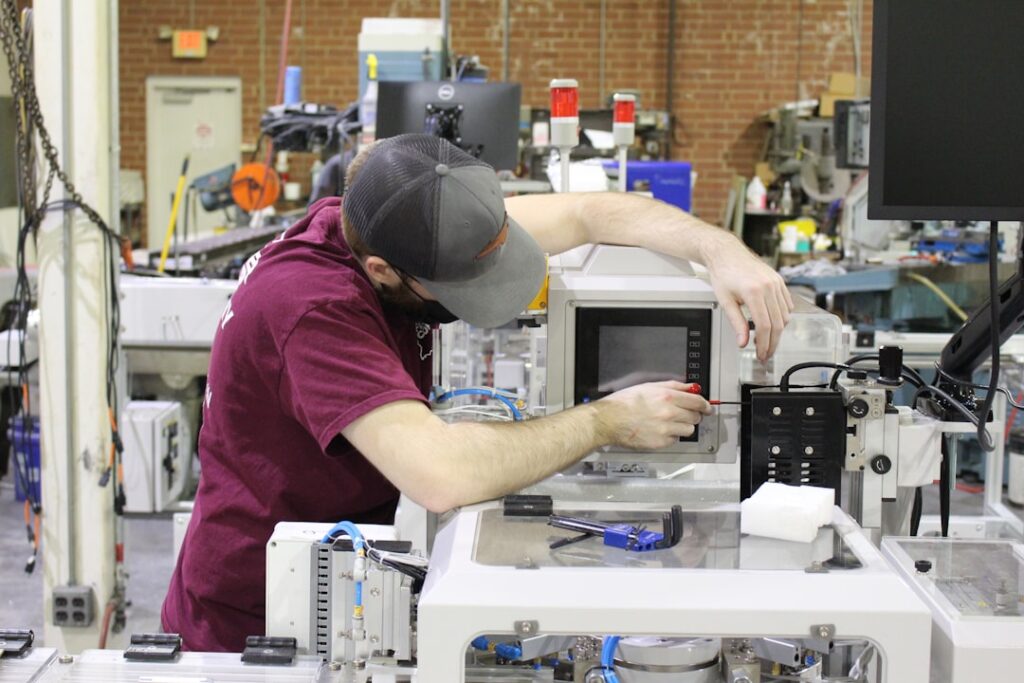 ASML CEO: No Competitors Threatening Our Chip Equipment Dominance man in red t-shirt and black cap in front of white and black microwave oven