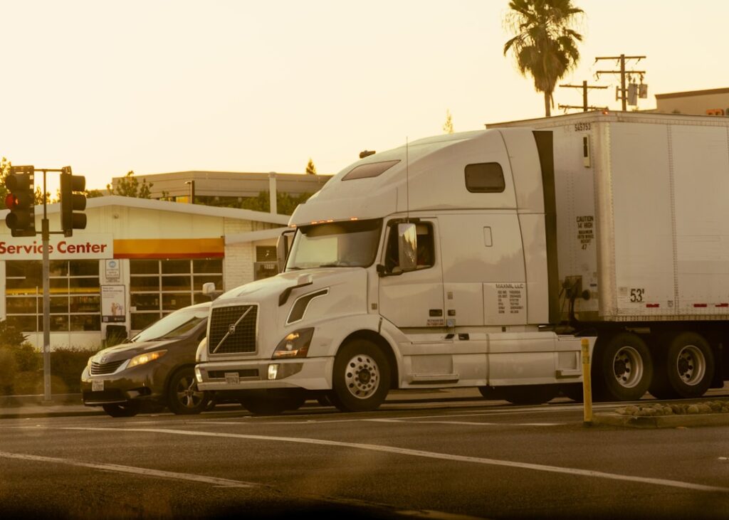 Avride Under Federal Investigation for Self-Driving Crashes A semi-truck crosses a road next to a car.