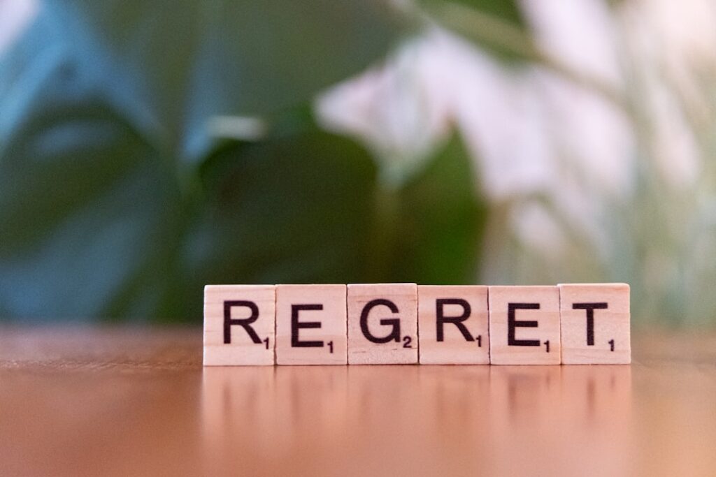 CEO Regrets: Leadership Lessons From the Top A scrabble block spelling the word regret on a table