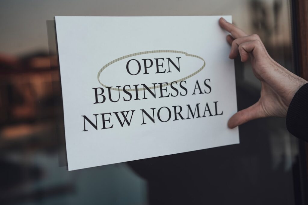 Commercial Lending Criteria: What Banks Really Want a person holding a sign that says open business as new normal