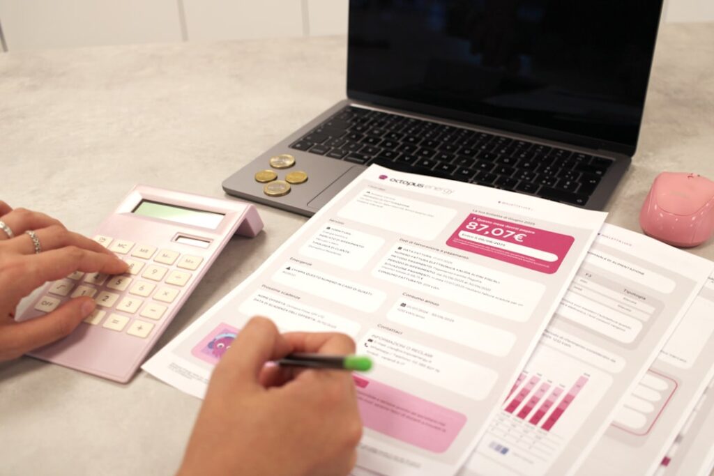 Essential Bookkeeper Tasks for Business Success Someone is calculating their finances with documents.