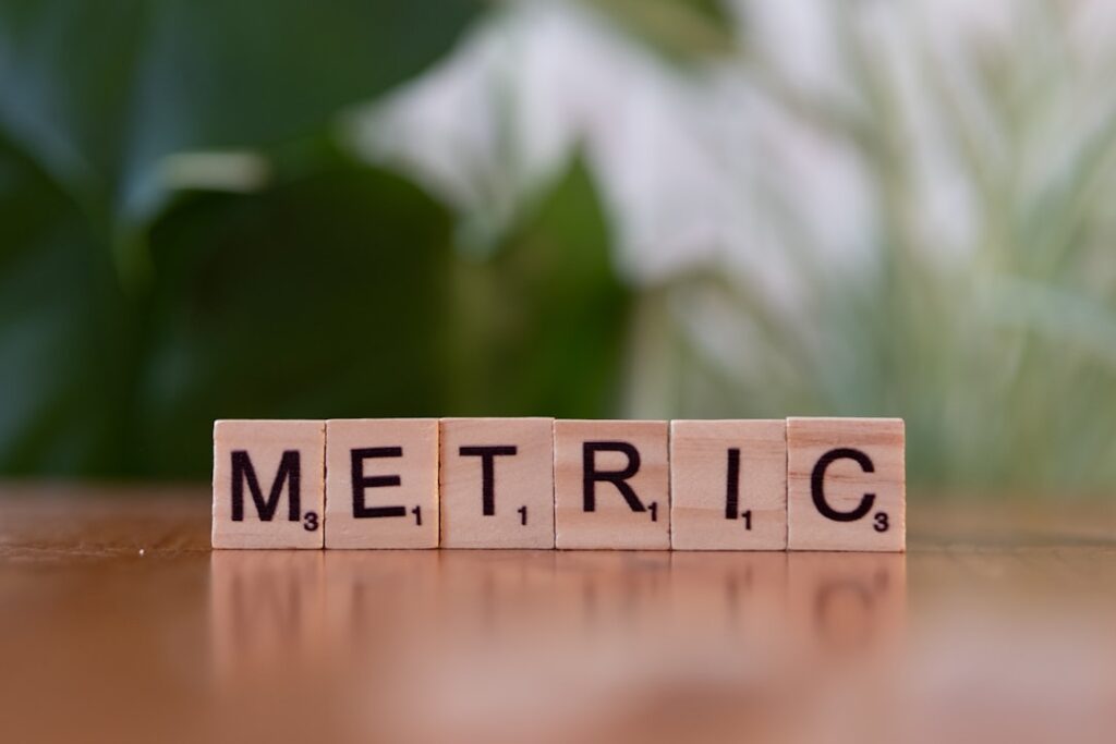 Essential Customer Experience Metrics Every Business Needs A wooden block spelling the word metallic on a table