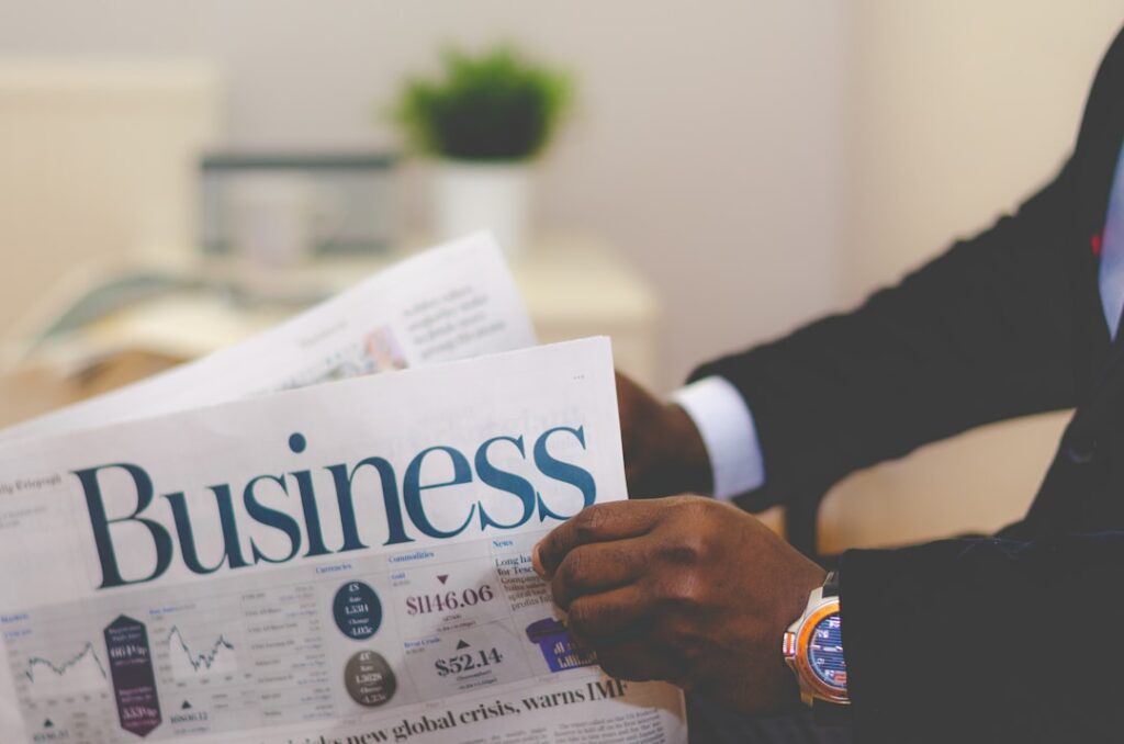 Fast Business Loans: Quick Capital for Growth Opportunities person wearing suit reading business newspaper
