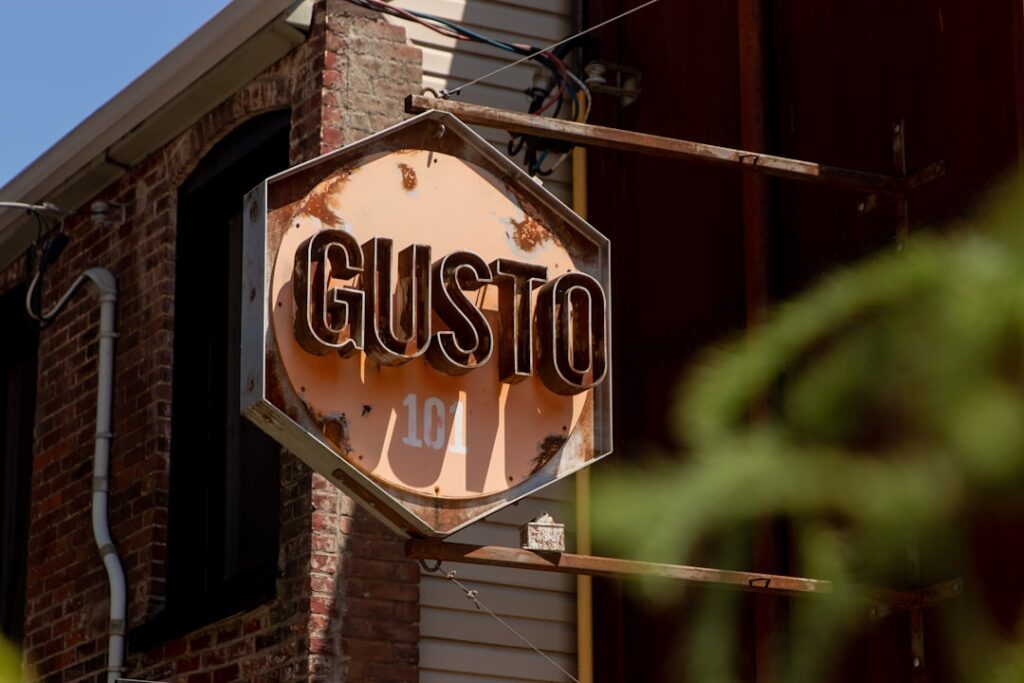 Gusto Reaches $1B Revenue Milestone, Eyes IPO Path a rusted stop sign hanging from the side of a building
