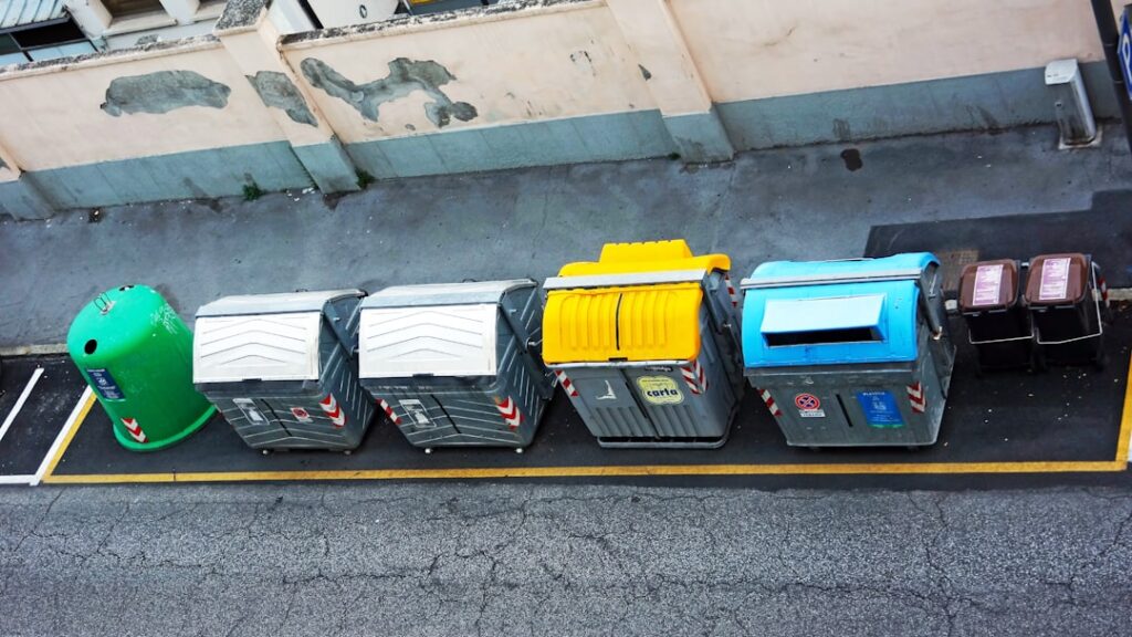 Humanoid Robots Transform Waste Sorting as Labor Shortage Bites a row of trash cans sitting on the side of a road