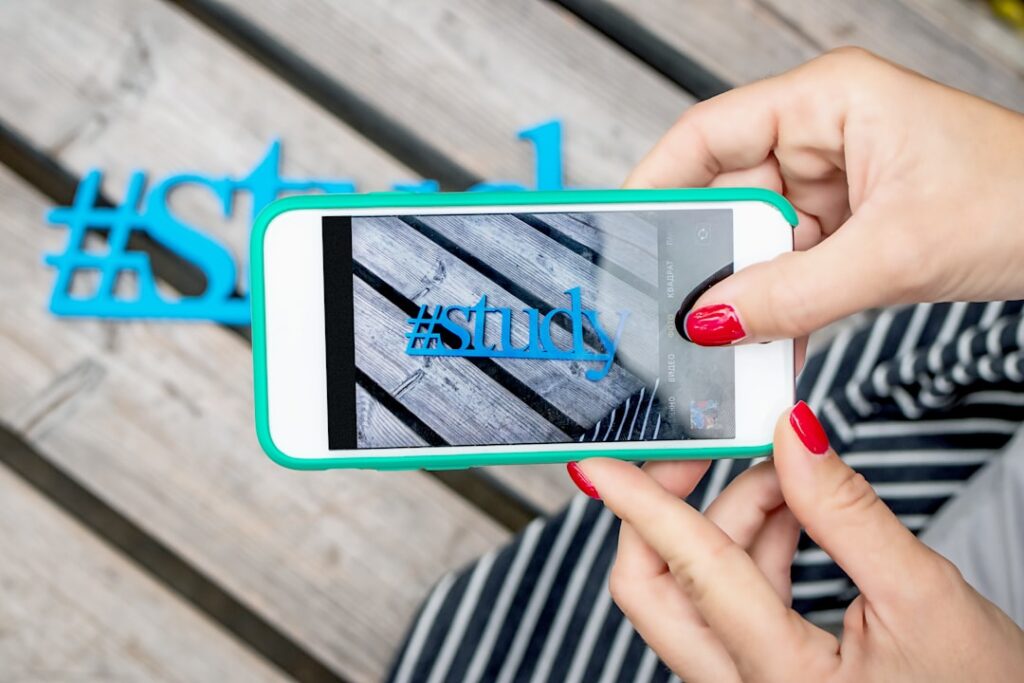 Instagram Hashtags That Drive Real Engagement Results woman using white smartphone taking photo