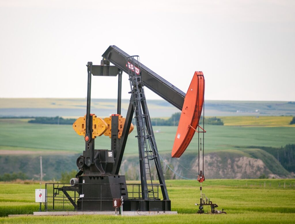 Iran Conflict Impact on UK Mortgages, Jobs, Energy black and orange metal machine on green grass field during daytime