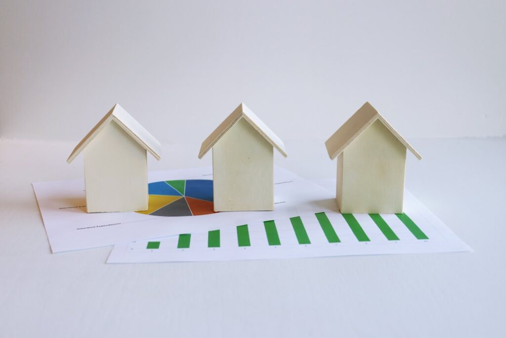 Jersey Housing Market Faces Geopolitical Headwinds three small houses sitting on top of a piece of paper