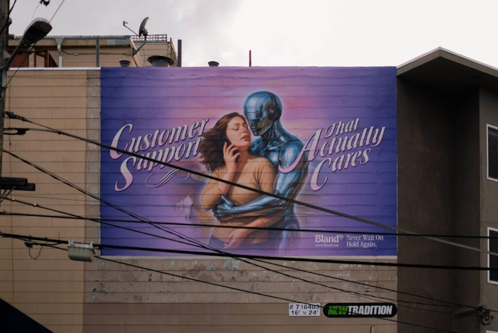 Klarna CMO Deploys AI Clone to Handle Customer Complaints Billboard with woman and robot embracing