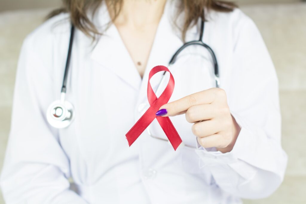 Norgine's PEDMARQSI Wins Australian TGA Approval a woman in a white shirt holding a red ribbon
