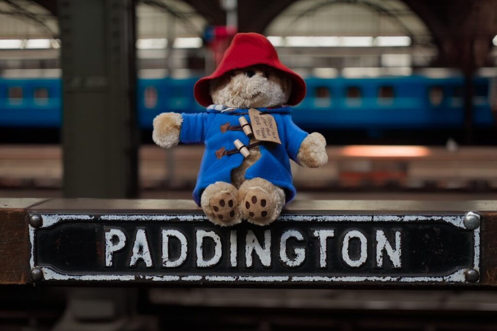 Paddington Bear Police Escort: Crime News Roundup A teddy bear sitting on top of a street sign