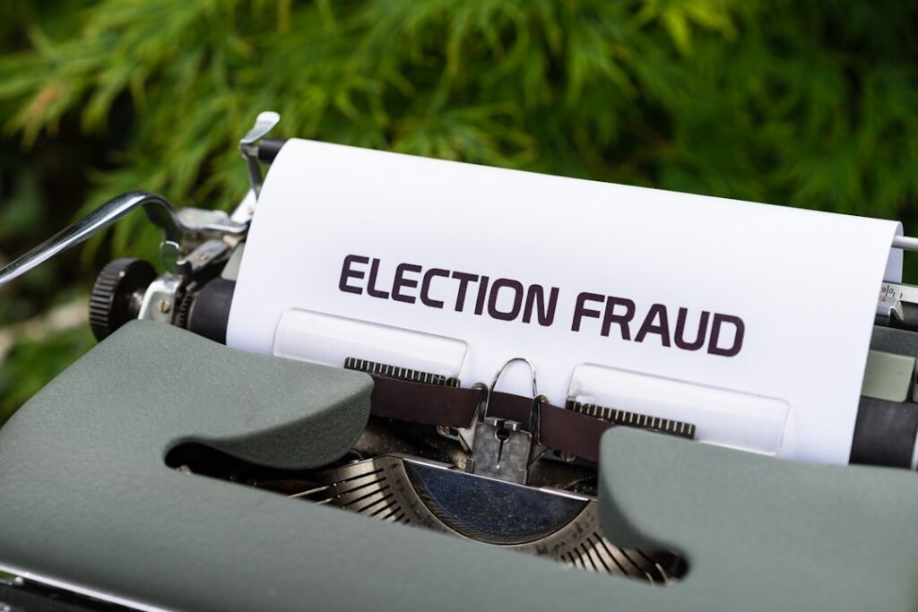 Pastor Indicted in $20M PPP Fraud Scheme a close up of a typewriter with a paper that reads election fraud