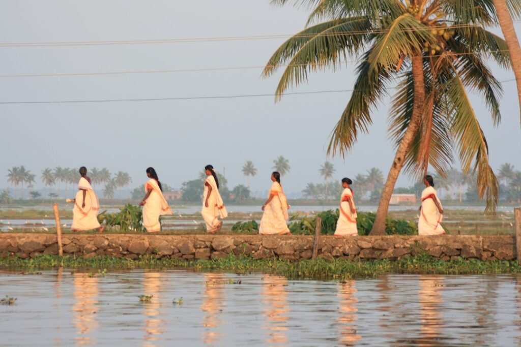 PKU's South-South Institute Celebrates a Transformative Decade A group of women walking across a river