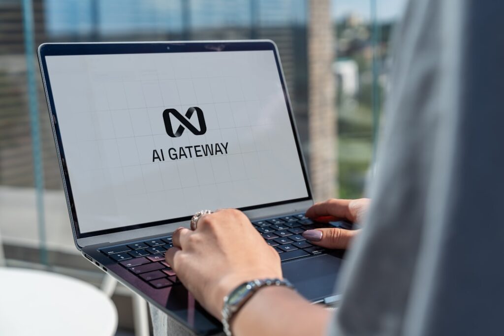 Sierra Raises $950M to Lead Enterprise AI Revolution Person typing on laptop with ai gateway logo.