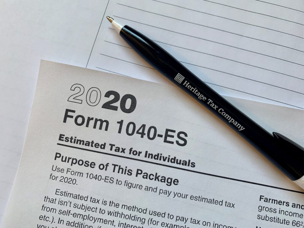 Sole Proprietor Tax Guide: What You Really Owe a pen sitting on top of a tax form