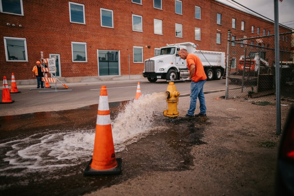 South East Water CEO Resigns Following Major Supply Crisis a man standing next to a yellow fire hydrant