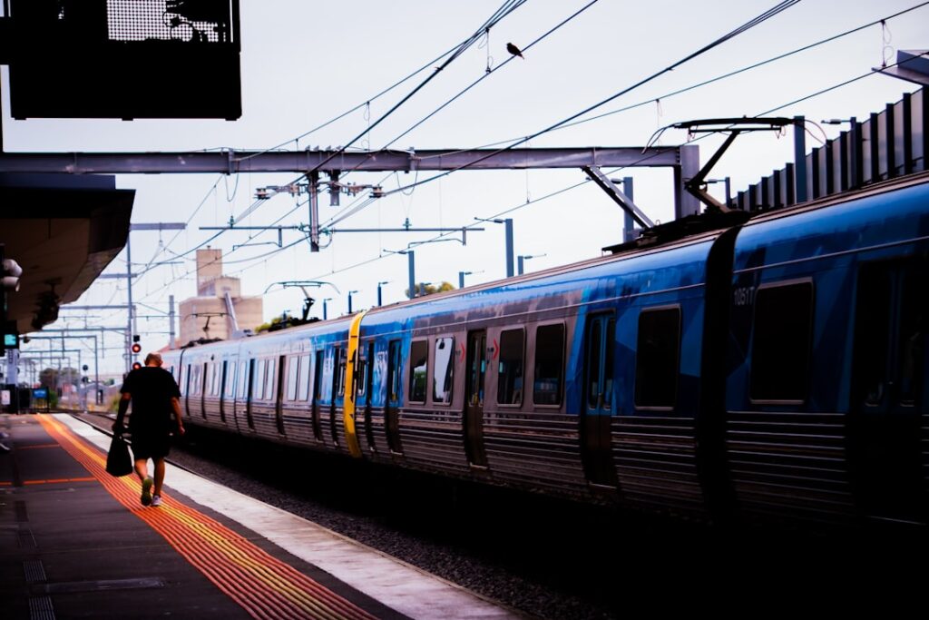 Southern England Rail Disruption Continues Despite Technical Fix A man walking next to a train at a train station