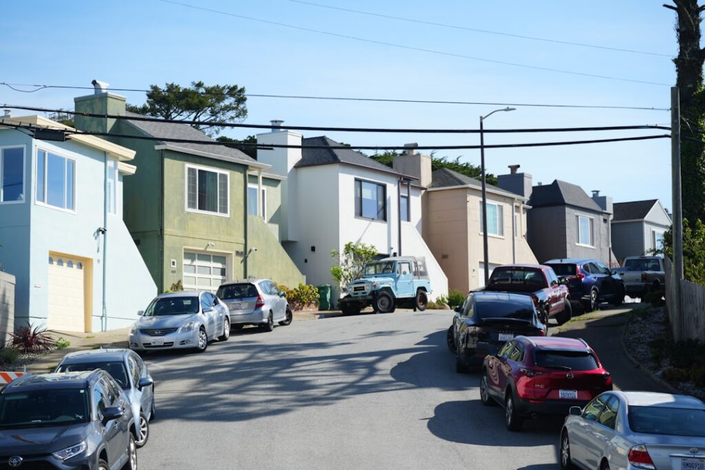 Tech Wealth Fuels San Francisco Housing Crisis Cars parked on a residential street with houses.