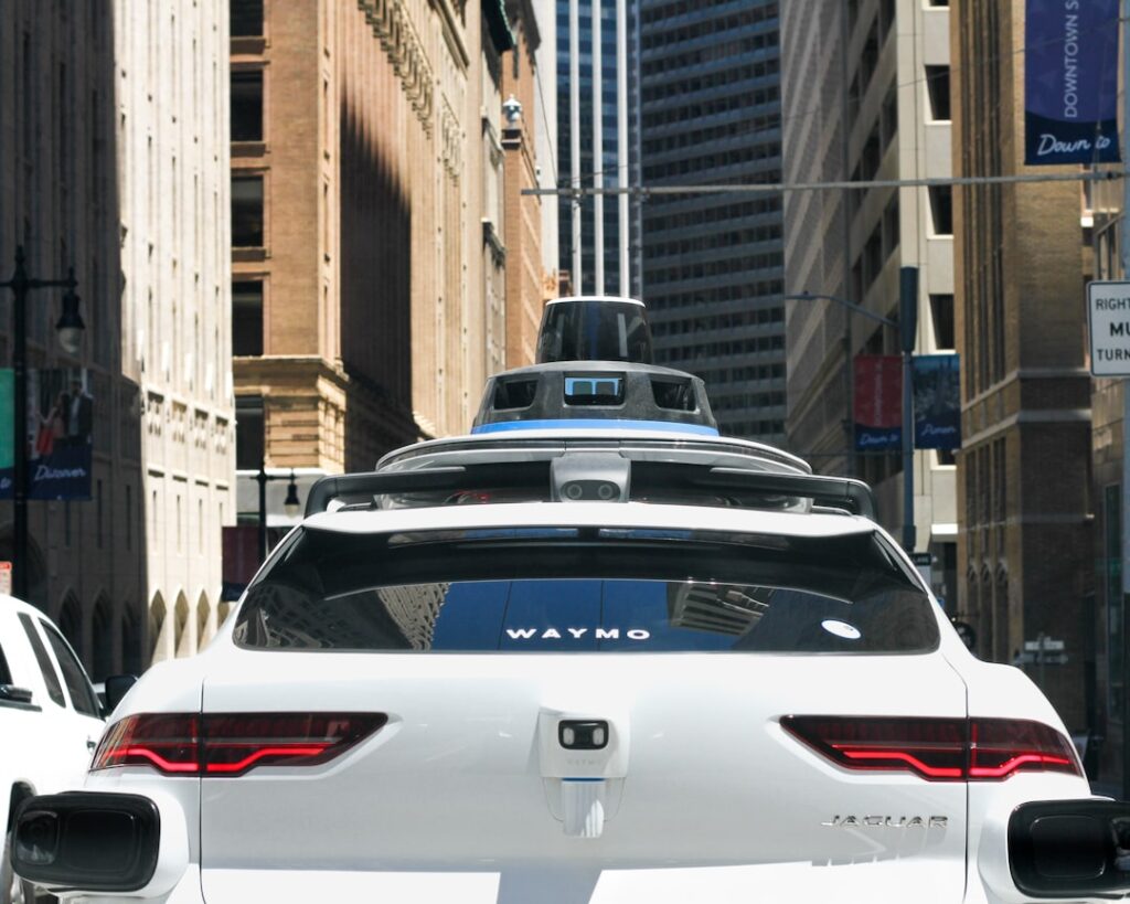 Ticketing Robotaxis: A Legal Gray Area Emerges a car that is driving down the street