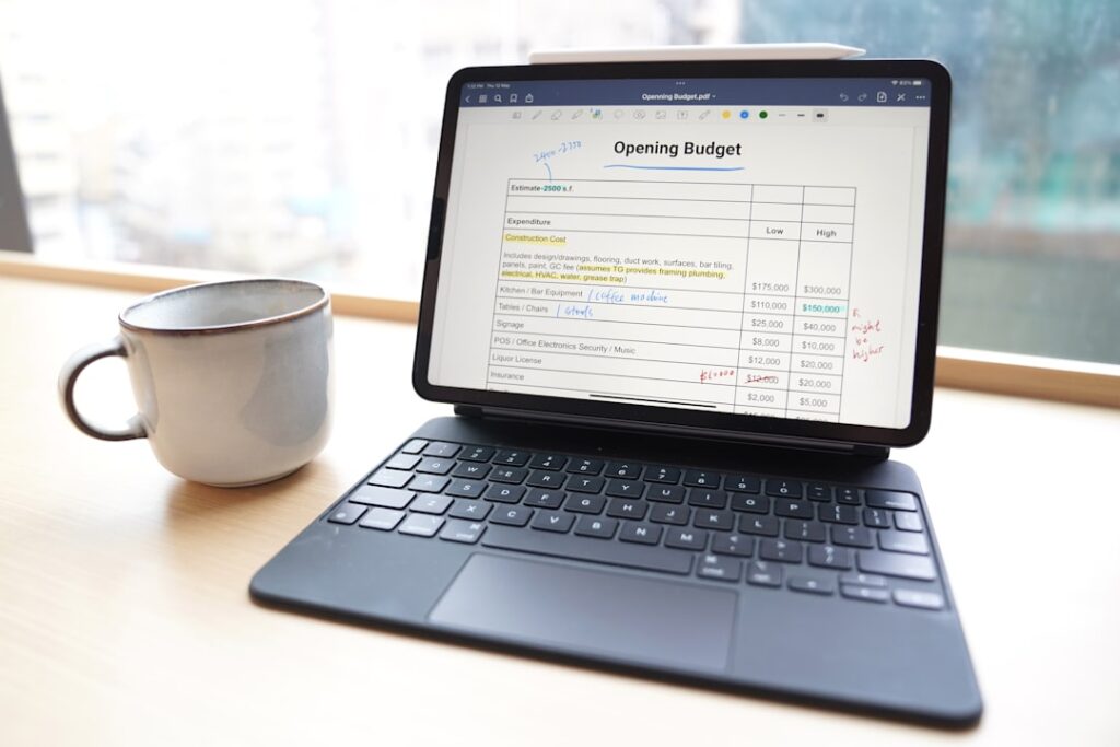 Top 10 Online Bookkeeping Services for Small Business a laptop and a cup of coffee