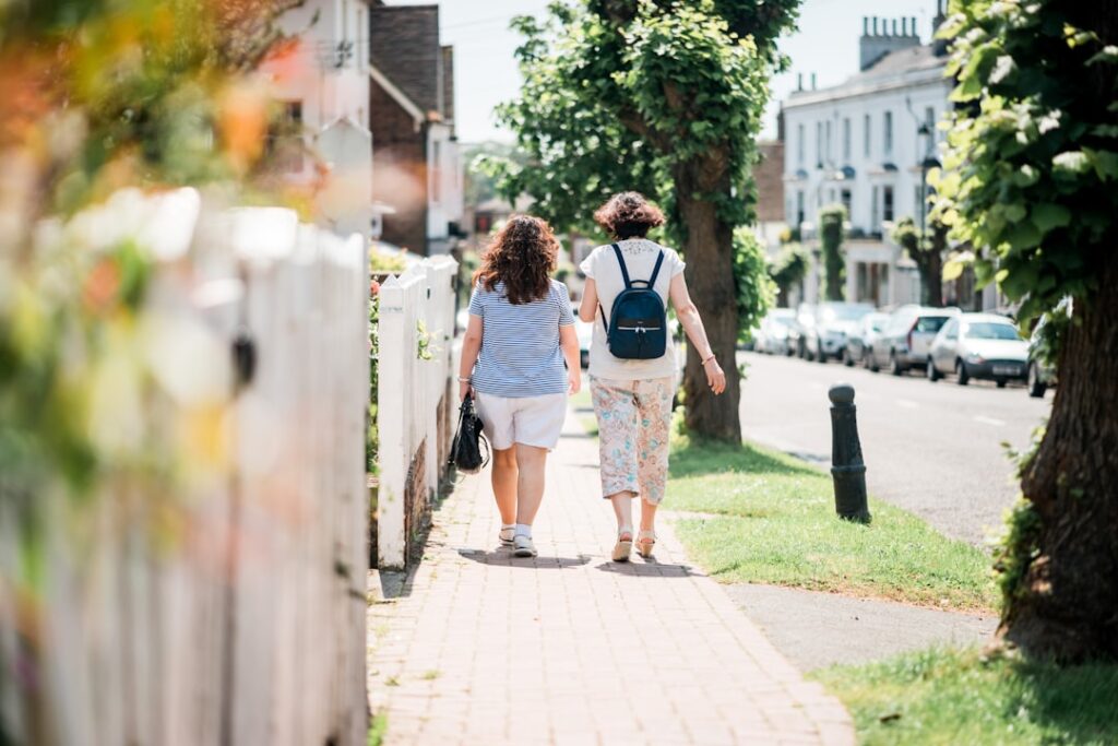 UK Borrowing Costs Hit 28-Year Peak Amid Election Jitters two women walking down sidewalk near fence