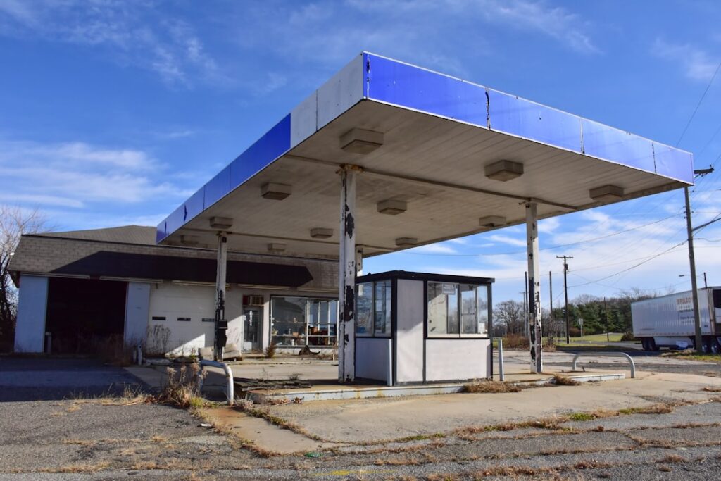 UK Fuel Prices Face Upward Pressure Amid Iran Tensions an old gas station with a blue roof