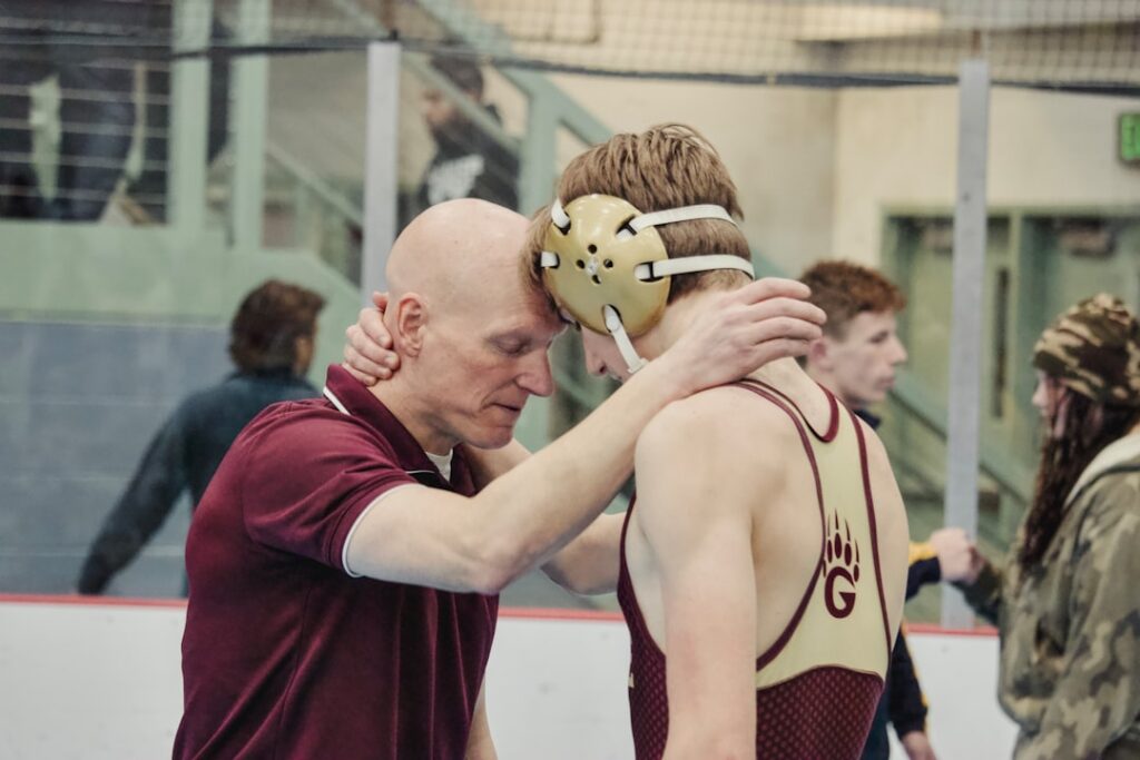 Why 'Follow Your Passion' Is Terrible Career Advice Coach and wrestler embrace after match.