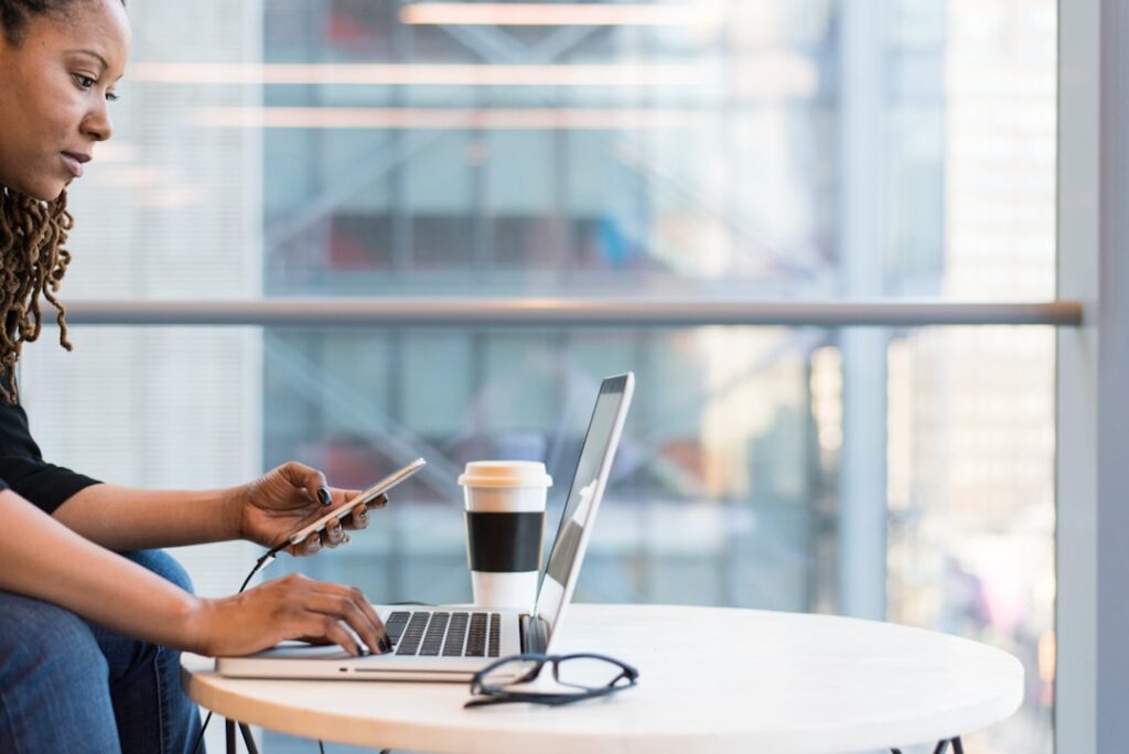 Will iMessage Work Chats Disappear by 2026? woman using MacBook