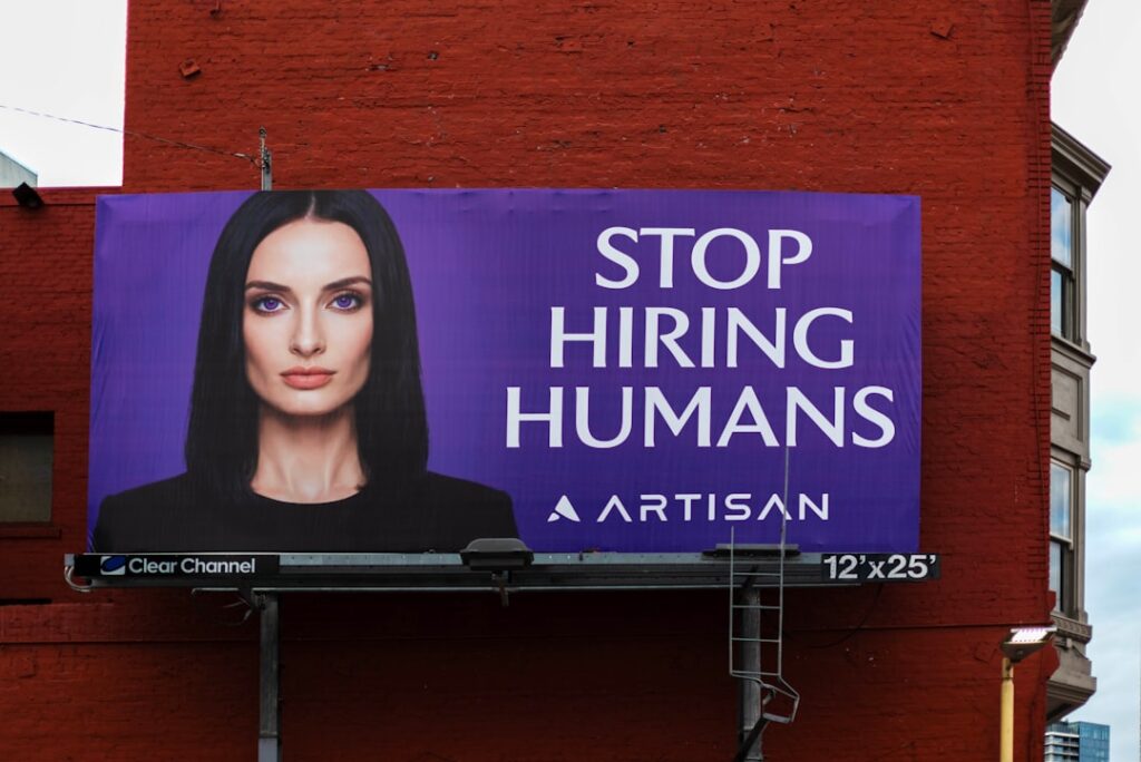 Workday's AI Agent Cuts Federal HR Processing by 60% Billboard with woman and text "stop hiring humans"