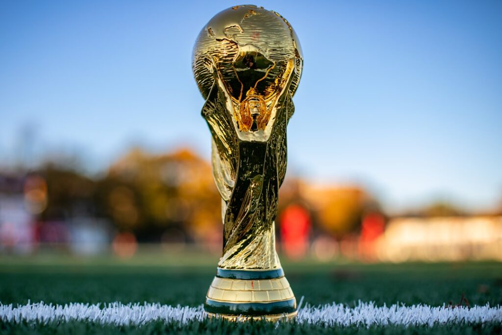 World Cup Broadcasting Crisis Looms in China and India a soccer ball sitting on top of a golden trophy
