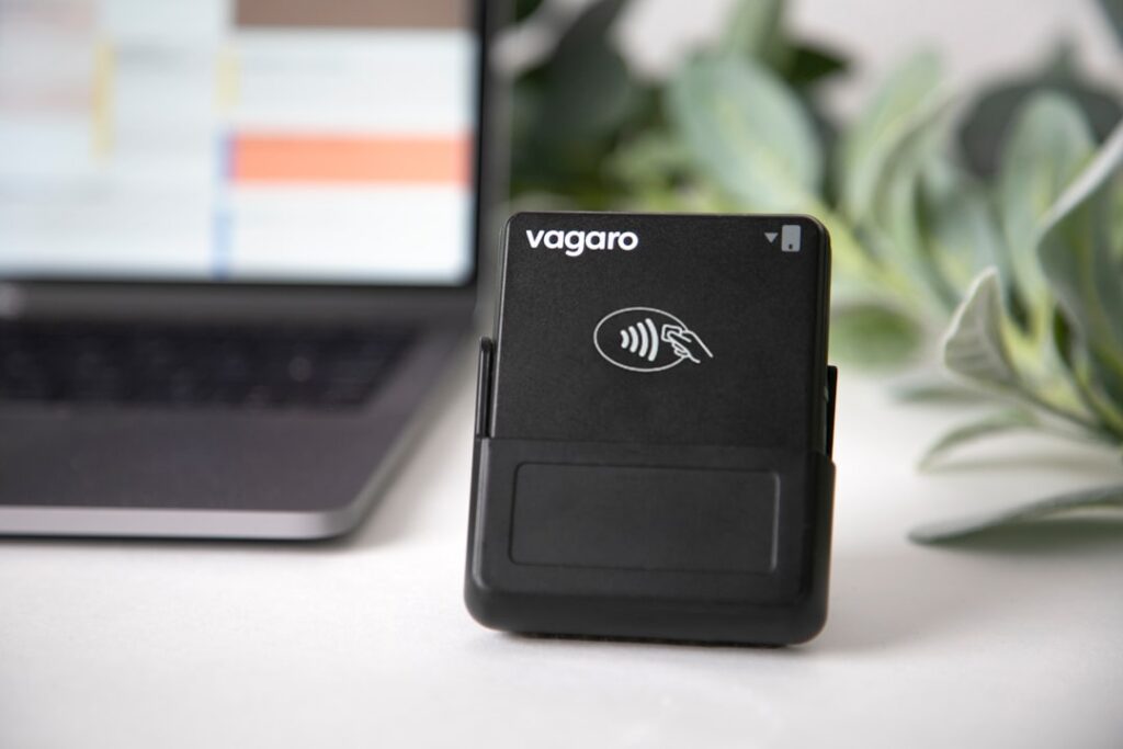 Xteink X3 E-Reader: MagSafe Device Fights Phone Addiction A vagaro card reader sits next to a laptop.